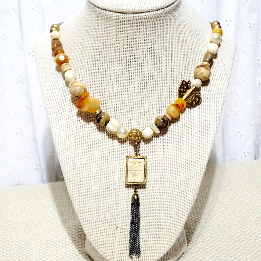 Silver and Gold Tone Necklace with a Bird, Butterfly and Beads.
